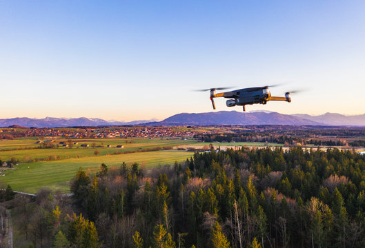Germany, Bavaria, Konigsdorf, Drone flying over rural grove at dusk