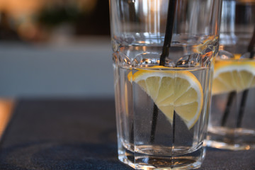 Water with lemon, drink, cocktail on the table in cafe with beautiful blurred background