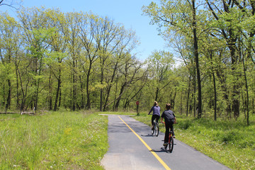 Mother and son riding bicycles on the North Branch Trail at Miami Woods in Morton Grove, Illinois