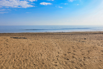 Fototapeta na wymiar Beautiful beach by the clear sea on a beautiful sunny holiday day