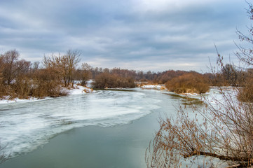 Thawing in the ice of a frozen river.