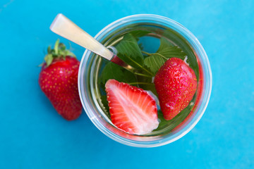 A Cup of hot tea with berries.