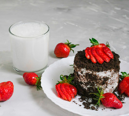 Tasty fresh milk on a white wooden background. homemade cookies and a glass of milk. Strawberry.Glass of milk and cake with strawberries and chocolate.