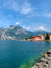 Fototapeta premium Beautiful view of a large blue lake in the mountains against the sky with clouds. Nature, summer landscape. Copy space for text.