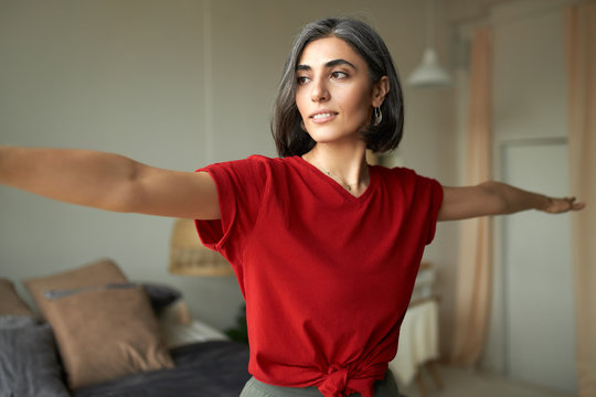 Close up cropped image of beautiful young woman with canities or doing hatha yoga at home instead of gym because of social distancing, choosing healthy active lifestyle, smiling, full of energy