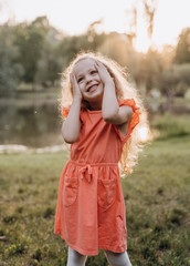 very happy little girl clings to her cheeks