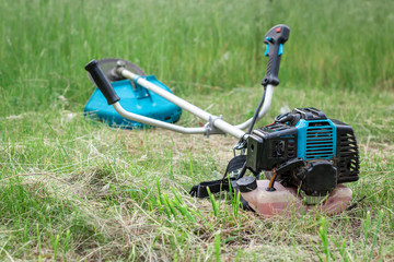 grass trimmer, lying on the ground