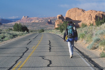 A man walking on the highway, Arches National Park, UT