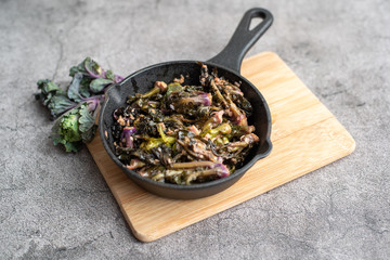 Sautéed kalettes, cooked in butter and garlic in a cast iron pan.