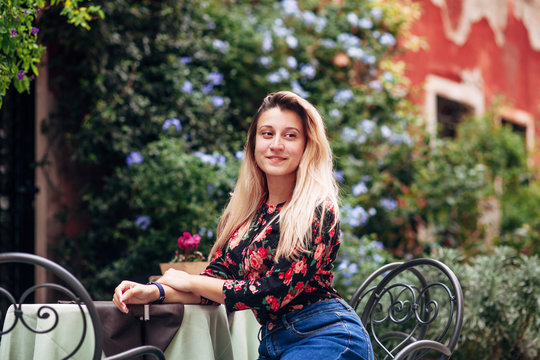 woman sitting at a table in a cafe