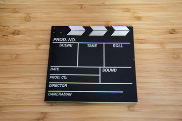 Movie clapper, movie slate notebook on the bamboo table
