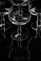 Champaign glasses Gatsby - style on black backdrop with reflections 