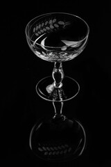 Champaign glasses Gatsby - style on black backdrop with reflections 