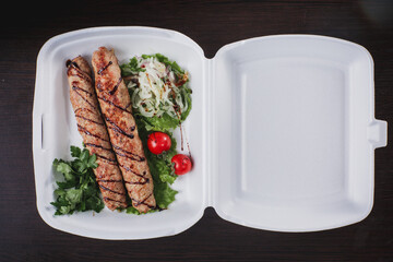 grilled sausages on a plate with vegetables