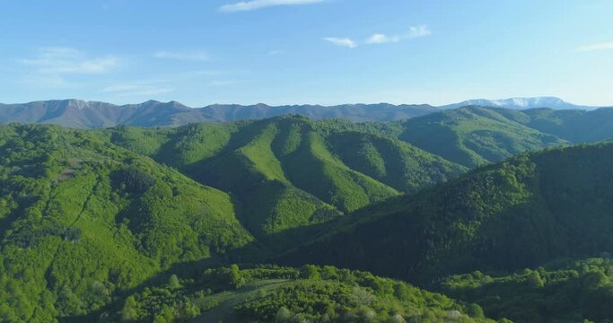 Aerial view of rolling green hills and forests
