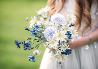 A bouquet of wild flowers in the girl's hands