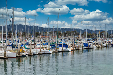 Fototapeta na wymiar Rows of fishing boats and yachts in Monterey Harbor