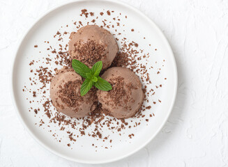  Bowl of chocolate ice cream on white wooden background. From top view..