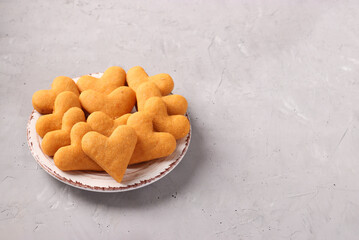 Heart shaped homemade cookies on a plate on a light gray background, Copy space