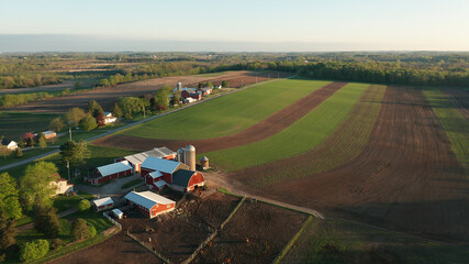 Aerial view of american countryside landscape. Farm, red barn, cows. Rural scenery, farmland. Sunny morning, spring summer season - obrazy, fototapety, plakaty