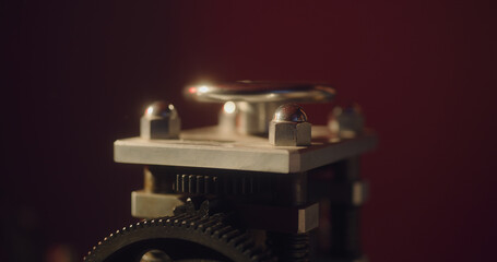 Shiny valve of some machine on a red dark background