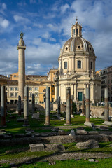 Obraz premium Rome, Italy: in close up archaeological ruins of the square of trajan forum, on the left of the image the trajan column, on the right the church of Santissimo nome di Maria.