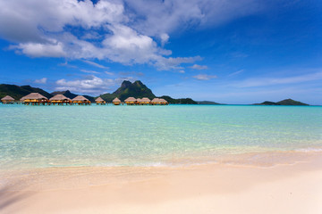 Bora Bora lagoon with mountains and overwater huts