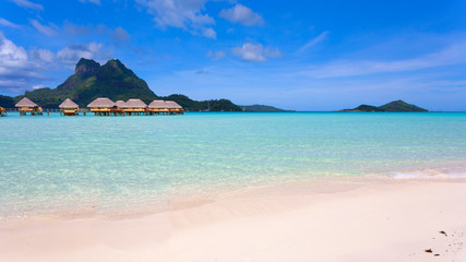 Fototapeta premium Bora Bora lagoon with mountains and overwater huts