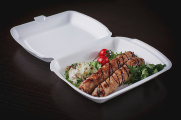 grilled pork on a bone with vegetables on a plate