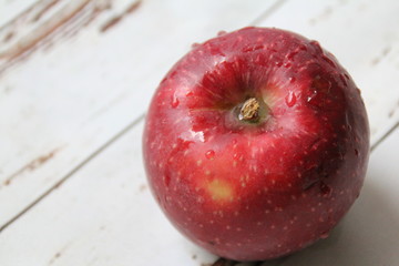 red apple with water drops