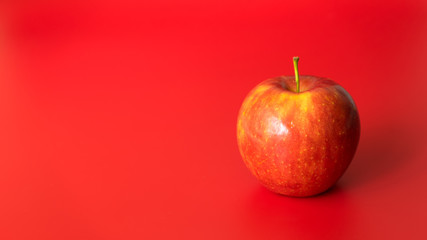 Red apples on a red background. Flat lay, top view