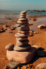 Fototapeta na wymiar Baltic Sea and stone balancing in the sun