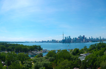Toronto Central Islands and Ward's Island Park beach, Ontario, Canada, aerial view from top at sunny greenery coast with boats and downtown gta at summer. Popular tourist location.
