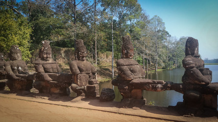 Statue of guardians in the bridge in Angkor Wat, cambodia, sunny day