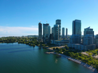 Obraz premium Panorama of Humber Bay Shores Park city view, green space with skyline cityscape downtown. Skyscrapers over The Queensway on sunset at summer time, near Etobicoke or New Toronto, Ontario, Canada