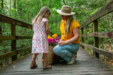 Mother Daughter with Flowers Outside