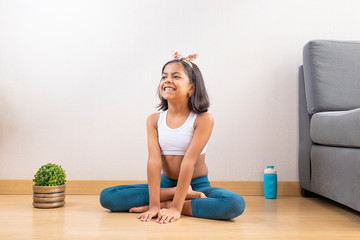 Teen girl doing yoga at home