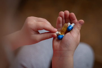 tablets and capsules in the child's palm