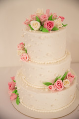A wedding cake with flowers looks very delicious.