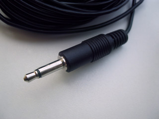mini jack 3.5mm jack on a small black cord lapel microphone