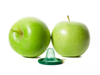 Unwrapped color condom with fruit flavor and green apples