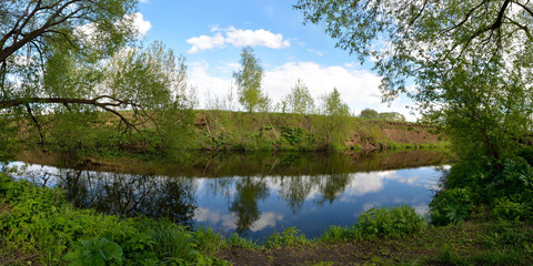 Spring fishing on the forest river, panorama.