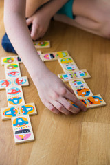 Child playing with a domino