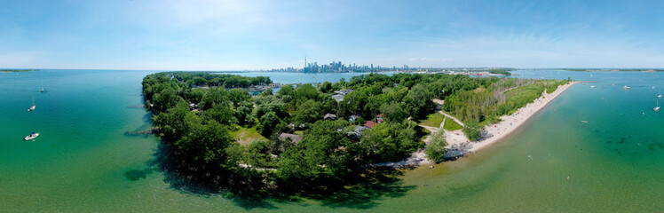 Toronto Central Islands and Ward's Island Park beach, Ontario, Canada, aerial view from top at sunny greenery and sandy coast with boats, people swimming at summer. Popular tourist location.