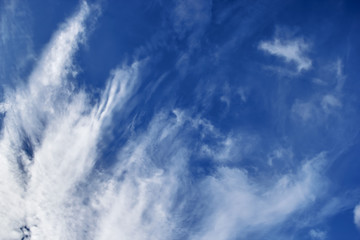 Cirrus clouds against a blue sky view from below