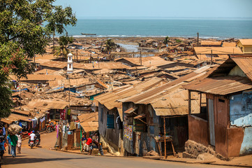Flimsy shacks with corrugated tin roofs make up a township near the coast of Freetown, Sierra...