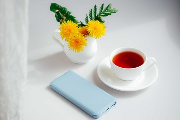 Morning tea with smartphone.