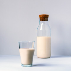 A glass of non dairy milk on white table. Healthy food concept