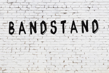 Word bandstand painted on white brick wall - obrazy, fototapety, plakaty