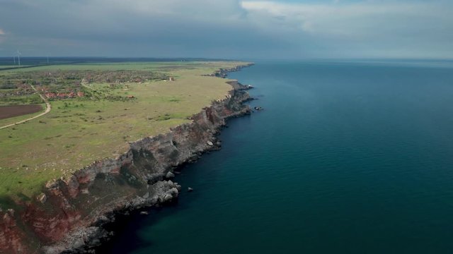 Panoramic video of picturesque rocky coastline with green fields and trees. Spring time at the Black sea coast, Yailata - national archeological and nature reserve, Bulgaria.